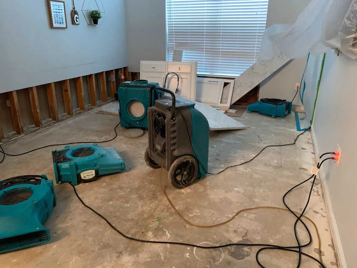 Dehumidifier in flood-cut room for Water Damage Restoration in Granville